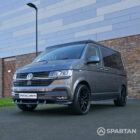 VW T6.1 Transporter in Indium Grey with a Spartan campervan conversion, parked outdoors with clean lines and a practical touring profile.
