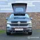 VW T6.1 Transporter in Indium Grey with a Spartan campervan conversion, parked outdoors with clean lines and a practical touring profile.