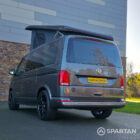 VW T6.1 Transporter in Indium Grey with a Spartan campervan conversion, parked outdoors with clean lines and a practical touring profile.