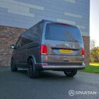 VW T6.1 Transporter in Indium Grey with a Spartan campervan conversion, parked outdoors with clean lines and a practical touring profile.