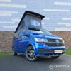 VW T6.1 Transporter in Ravenna Blue, fitted with a Spartan campervan conversion, parked outdoors. Clean lines, factory stance, and upgraded camper profile visible