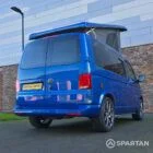 VW T6.1 Transporter in Ravenna Blue, fitted with a Spartan campervan conversion, parked outdoors. Clean lines, factory stance, and upgraded camper profile visible