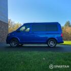 VW T6.1 Transporter in Ravenna Blue, fitted with a Spartan campervan conversion, parked outdoors. Clean lines, factory stance, and upgraded camper profile visible