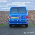 VW T6.1 Transporter in Ravenna Blue, fitted with a Spartan campervan conversion, parked outdoors. Clean lines, factory stance, and upgraded camper profile visible