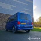 VW T6.1 Transporter in Ravenna Blue, fitted with a Spartan campervan conversion, parked outdoors. Clean lines, factory stance, and upgraded camper profile visible