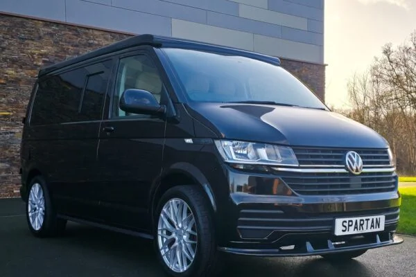 VW T6.1 Transporter campervan in gloss black with a spartan conversion from the front