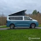VW Transporter T7 campervan, with full Spartan Campers conversion. Driver side on with pop top up