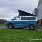 VW Transporter T7 campervan, with full Spartan Campers conversion. Passenger side on with pop top up