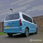 VW Transporter T7 campervan, with full Spartan Campers conversion. Rear drivers quarter with pop top down