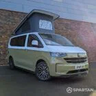VW Transporter T7 campervan with full Spartan Campers conversion in white and military green, drivers front quarter with the poptop roof up