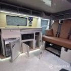 VW T7 Transporter with Spartan campervan conversion living space with all of the storage cupboards open
