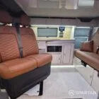 VW T7 Transporter with Spartan campervan conversion living space showcasing the kitchen appliances and seating configuration