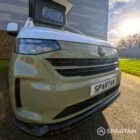 VW Transporter T7 campervan with full Spartan Campers conversion in white and military green, drivers front quarter with the poptop roof up
