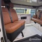 VW T7 Transporter with Spartan campervan conversion living space showcasing the swivel and slide front bench seat in rotated into the living area
