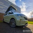 VW Transporter T7 campervan with full Spartan Campers conversion in white and military green, drivers front quarter with the poptop roof up