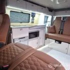 VW T7 Transporter with Spartan campervan conversion living space showcasing the kitchen appliances and seating configuration