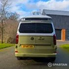 VW Transporter T7 campervan with full Spartan Campers conversion in white and military green, rear with the poptop roof up