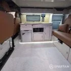 VW T7 Transporter with Spartan campervan conversion interior with winter flooring, latte and amber oak kitchen and fudge upholstery. Full interior shot