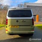 VW Transporter T7 campervan with full Spartan Campers conversion in white and military green, rear with the poptop roof down