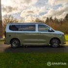 VW Transporter T7 campervan with full Spartan Campers conversion in white and military green, drivers side with the poptop roof down