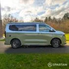 VW Transporter T7 campervan with full Spartan Campers conversion in white and military green, drivers side with the poptop roof down