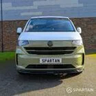 VW Transporter T7 campervan with full Spartan Campers conversion in white and military green, front on with the poptop roof down