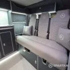 VW T7 Transporter with Spartan campervan conversion. Interior view with blizzard flooring, storm cloud and light grey kitchen showcasing the fabworx r&r bed and full length wardrobe