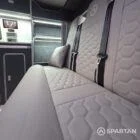 VW T7 Transporter with Spartan campervan conversion. Interior view with blizzard flooring, storm cloud and light grey kitchen showcasing the fabworx r&r bed and full length wardrobe
