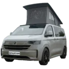 VW Transporter T7 campervan in two tone mojave beige with pop-top roof, passenger-side front quarter view.