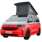 VW Transporter T7 campervan in two tone red with pop-top roof, passenger-side front quarter view.