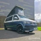 Spartan Campers VWT6 long wheel base campervan in bamboo and candy white. front drivers quarter with roof up