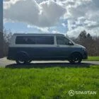 Spartan Campers VWT6 long wheel base campervan in bamboo and candy white. drivers side quarter with roof down