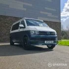 Spartan Campers VWT6 long wheel base campervan in bamboo and candy white. front drivers quarter with roof down