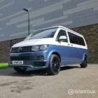 Spartan Campers VWT6 long wheel base campervan in bamboo and candy white. front passenger quarter with roof down