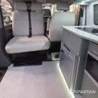 Spartan campers VW campervan with winter flooring, Italian Reed Green and Latte kitchen with Cookie upholstery. Fitted with a microwave, fridge/freezer, sink, wireless fast charger, rock and roll bed, and swivel and slide passenger bench seat