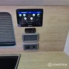 VW T7 Short wheelbase Spartan campervan interior with a passenger bench seat and mobiframe bed on rails. Winter flooring, latte and winchester oak kitchen