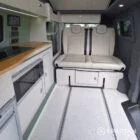 VW T7 SWB with full Spartan Campers conversion. winter flooring, latte and italian reed green kitchen, real wood worktop and cookie upholstery