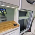 VW T7 SWB with full Spartan Campers conversion. winter flooring, latte and italian reed green kitchen, real wood worktop and cookie upholstery