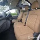 SWB VW T7 with Spartan Campers conversion, interior with winter flooring, latte and Italian reed green kitchen, liquor upholstery. Including a microwave, fridge/ freezer, rock and roll bed, double gas burner and sink