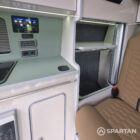 SWB VW T7 with Spartan Campers conversion, interior with winter flooring, latte and Italian reed green kitchen, liquor upholstery. Including a microwave, fridge/ freezer, rock and roll bed, double gas burner and sink