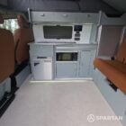 SWB VW T7 with full Spartan Campers conversion. With winter flooring, seagrass and white kitchen and toffee upholstery