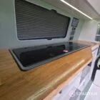 VW T7 SWB with full Spartan Campers conversion. winter flooring, latte and italian reed green kitchen, real wood worktop and cookie upholstery