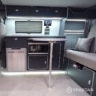 VW T7 with full Spartan Campers Conversion, featuring a rock and roll bed, captains seat, microwave, fridge/freezer, double gas hob, sink, touch screen savvy panel and hot water system