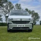 VW T7 in Meadow Green, front, pop top down