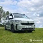 VW T7 in Meadow Green, front drivers quarter, pop top down