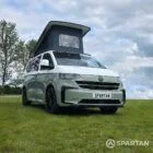 VW T7 SWB in Meadow Green front drivers quarter, pop top up