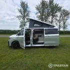 VW T7 in Meadow Green, passengers side, pop top up, doors open