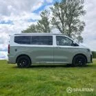 VW T7 in Meadow Green, drivers side, pop top down