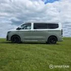 VW T7 in Meadow Green, passengers side, pop top down