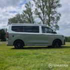 VW T7 in Meadow Green, drivers side, pop top down